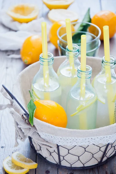 Basket lemonade bottles — Stock Photo, Image