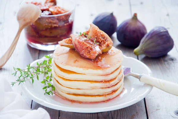 A stack of homemade pancakes with fig jam on a white plate Stock Photo