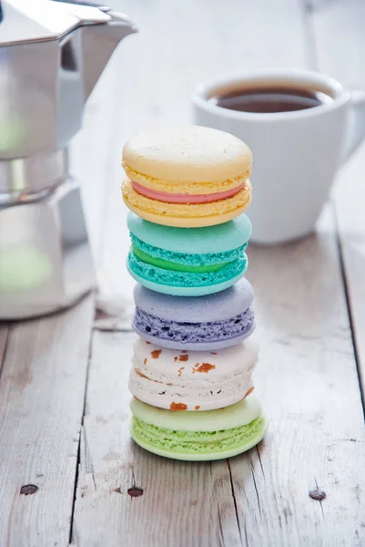 Stack of French colorful macarons in background on grey wooden background — Stock Photo, Image