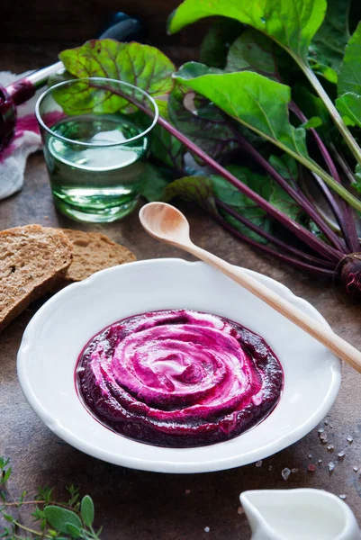 Creamy Beetroot soup on brown wooden background Stock Picture