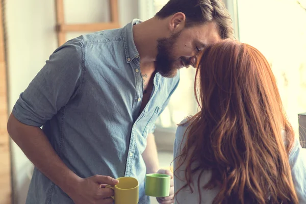 Couple sitting at kitchen Royalty Free Stock Images