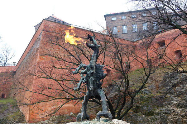 Dragon Statue is emitting flame from the mouth, in the old city of Krakow