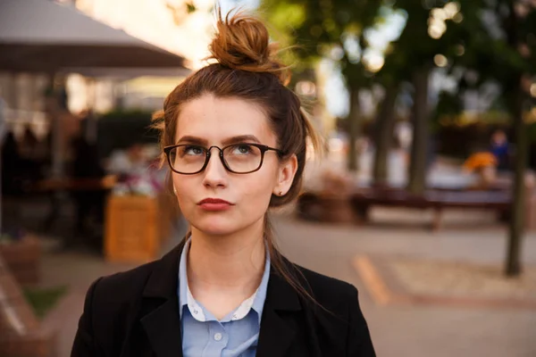 Retrato de mujer joven en gafas está reflexionando al aire libre . —  Fotos de Stock