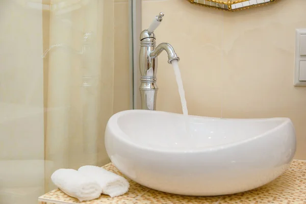 El agua sale del grifo. Interior moderno cuarto de baño . — Foto de Stock