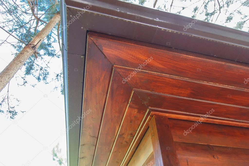 Wooden soffit in a wooden house made of a log.
