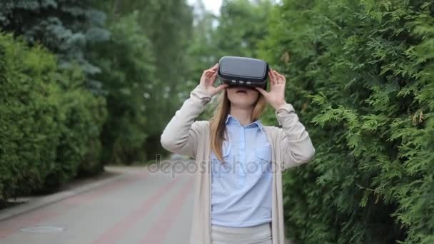 Mujer joven viendo vídeo por auriculares de realidad virtual . — Vídeos de Stock