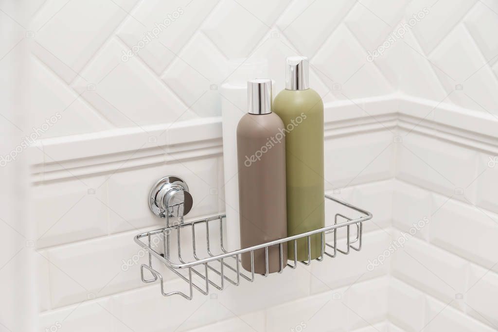 Toiletries bottles on suction cups compact bath shelf, fixing on tiled wall without drilling
