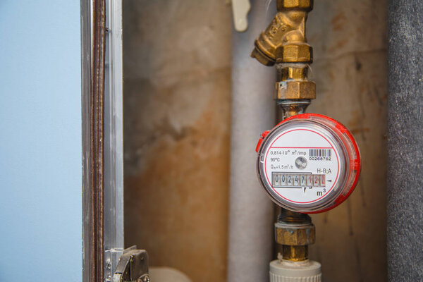 Hot water meter with filter on pipe in flat. Municipal water metering