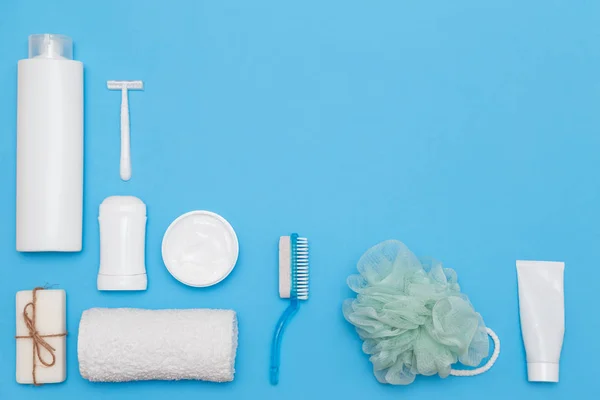 Body and skin hygienic care toiletry products, in white packaging on a blue background. Flat lay. Copy space — Stock Photo, Image