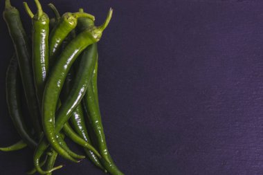 Siyah taş üzerinde bir demet biber. 