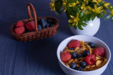 berries in a basket and granola on a table