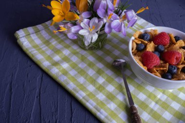 breakfast with crunchy muesli in a cup, a spoon lies