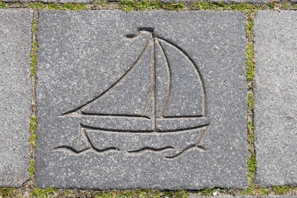 drawing of a boat on a stone sidewalk in an old European port city in spring