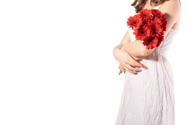 young girl holding a bouquet of gerbera flowers on a white background