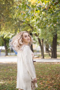 Güz parkında yürüyen güzel bir kadın
