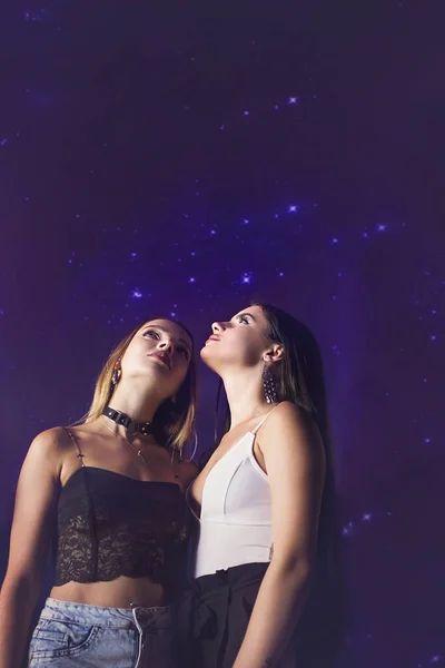 two friends in love against the starry sky