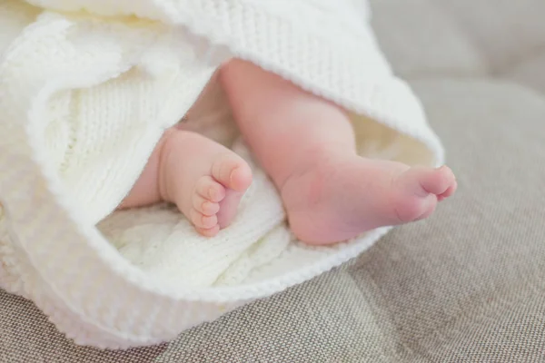 Neugeboren. Babyfüße mit einer Decke bedeckt — Stockfoto