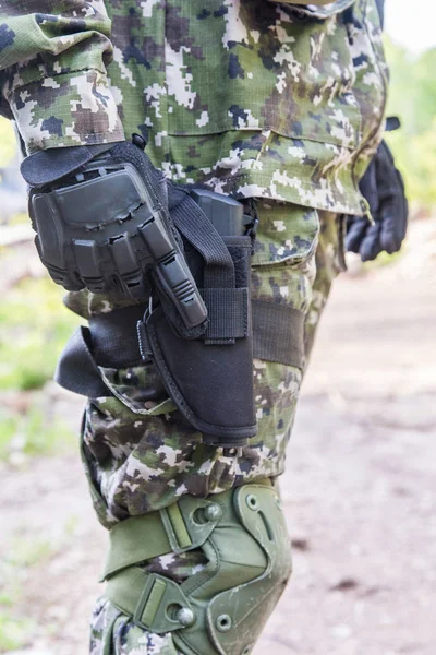 Elements military uniform. The gun is hanging on the thigh