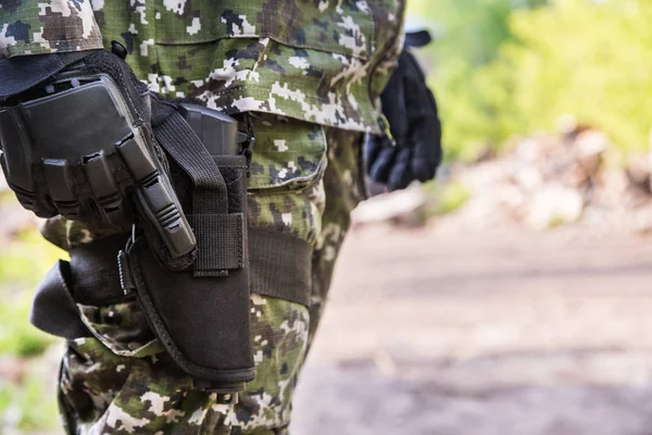 Elements military uniform. The gun is hanging on the thigh