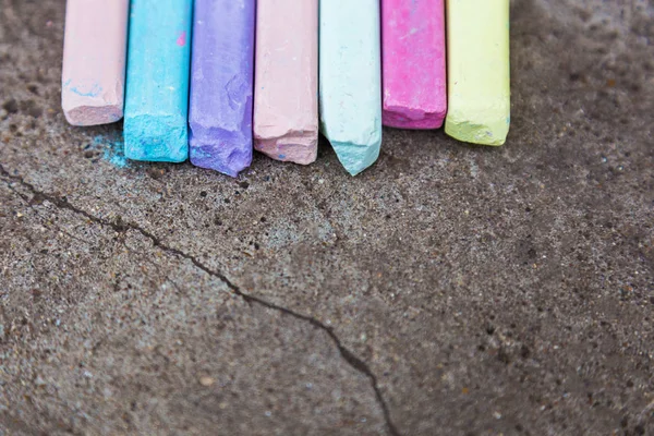 Bunte Kindermalstifte auf dem Asphalt hautnah — Stockfoto