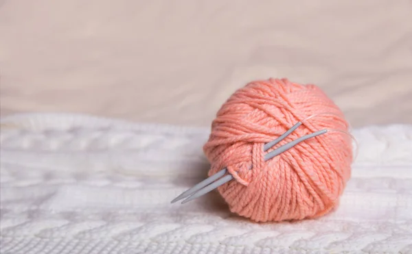 tangle with pink thread on white knitted background