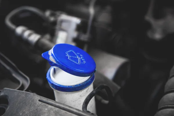 closeup blue windshield washer fluid reservoir cap in engine room