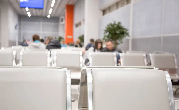 seat and people blurred in the airport waiting room