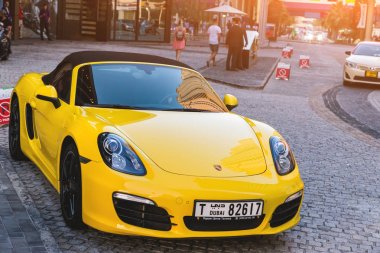 Dubai, Birleşik Arap Emirlikleri 14 Şubat 2018: Sarı Porshe bir şehir sokak üzerinde