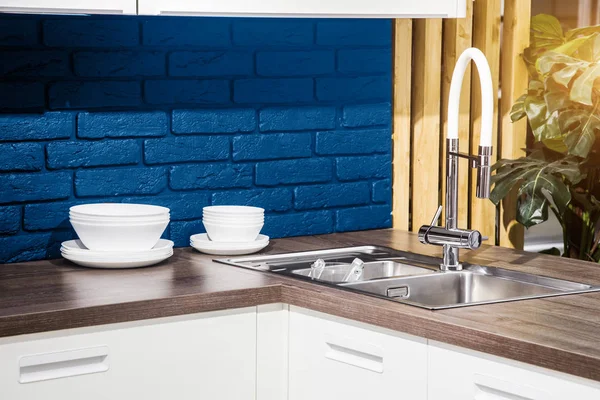 Modern kitchen interior. sink and faucet. classic blue color wall brick. — 스톡 사진