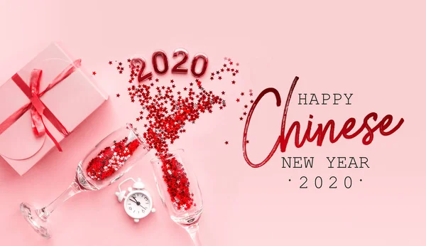 Flatlay Christmas composition on a pastel pink background. Glasses with champagne, confetti. Chinese New Year 2020 — 스톡 사진