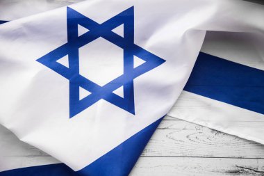 Close up shot of wavy blue and white Israeli flag. Happy independence day Israel, top view, flat lay