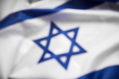 blurred background, Close up shot of wavy blue and white Israeli flag. Happy independence day Israel, top view, flat lay