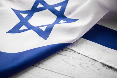 Close up shot of wavy blue and white Israeli flag. Happy independence day Israel, top view, flat lay