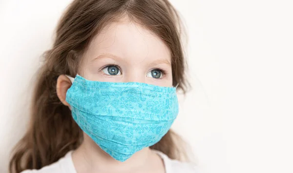 Zero wastle. Child girl in reusable fabric medical face masks, virus protection during an epidemic.