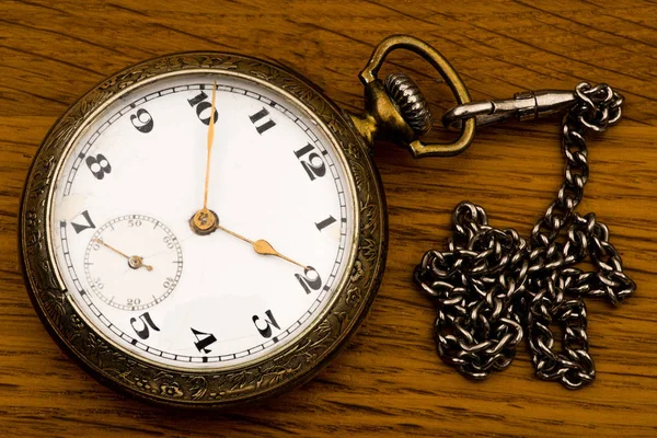 An antique pocket silver watch with a chain on a background of a — Stock Photo, Image