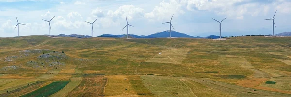 Panoramic view of yellow fields with a line of windmills. Montenegro, Niksic, Krnovo wind park — Stock Photo, Image