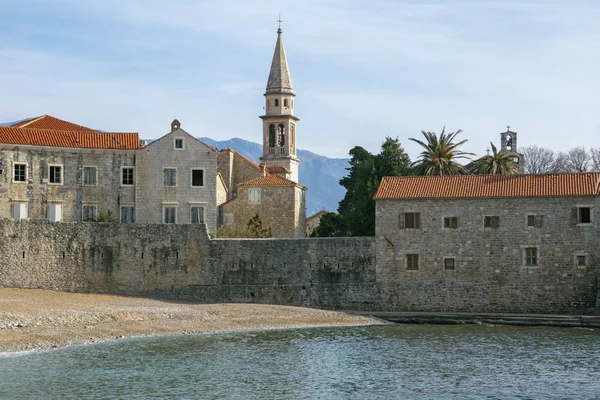 Ancient Mediterranean architecture. View of the Old Town of Budva - one of oldest urban settlements on Adriatic coast. Bell tower of Church of St. John. Montenegro — Stockfoto