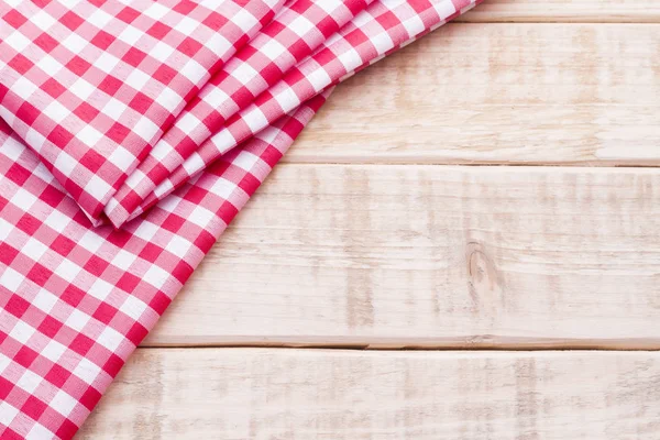 Red table cloth on wooden background