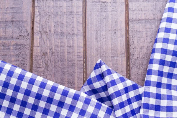Blue table cloth on wooden background
