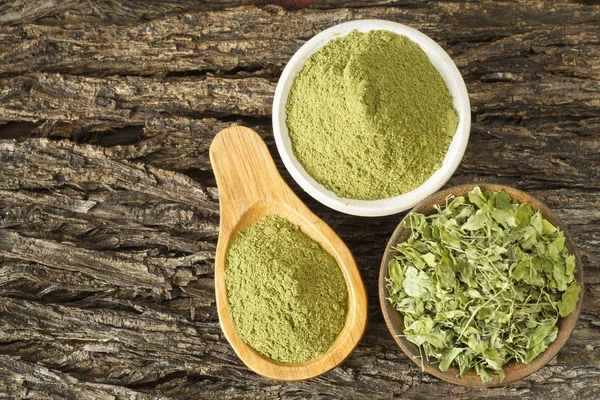 Hojas y polvo de moringa sobre madera (moringa oleifera ) —  Fotos de Stock