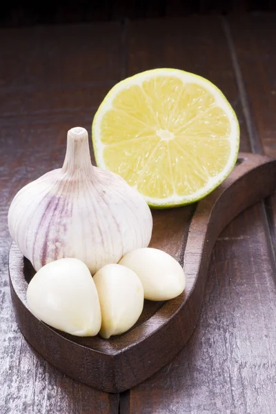 Garlic with lemon on wood