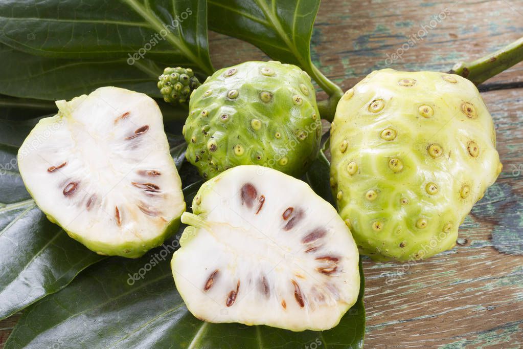 Noni stacked on wood - Morinda citrifolia