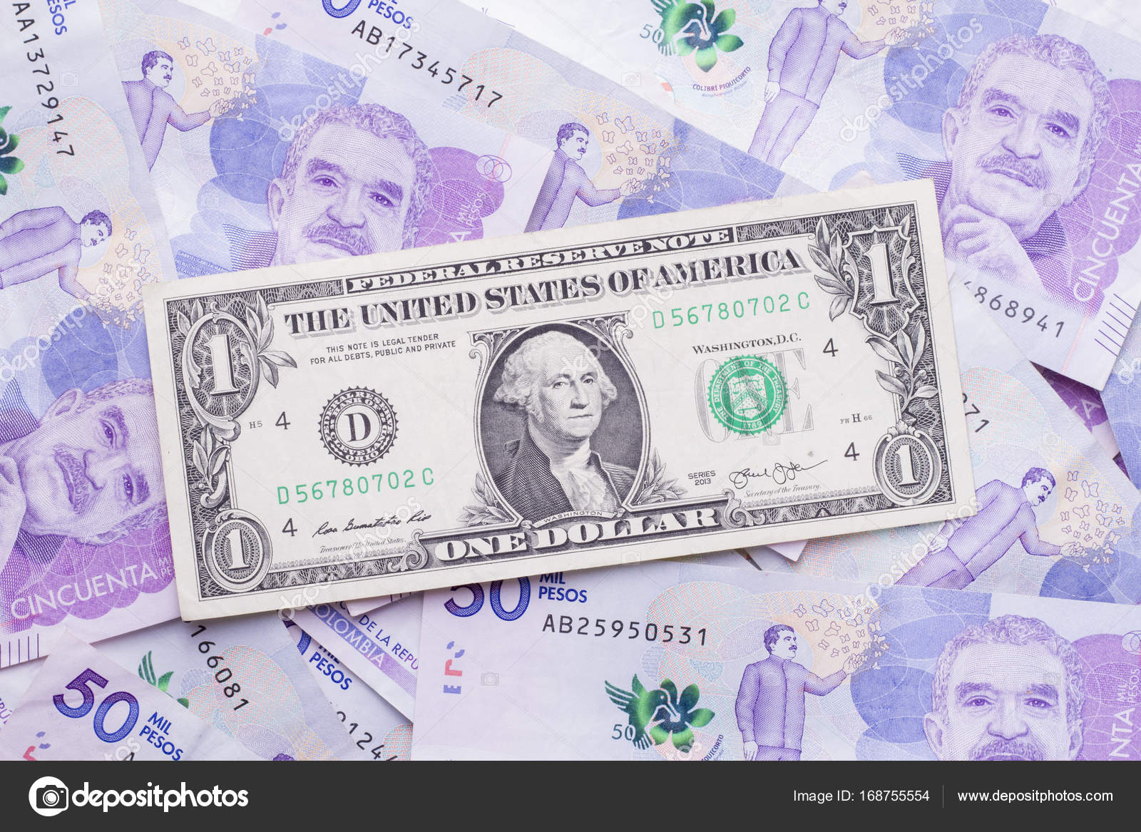 A dollar bill on bills of 50 thousand Colombian pesos — Stock Photo © CUNDO  #168755554