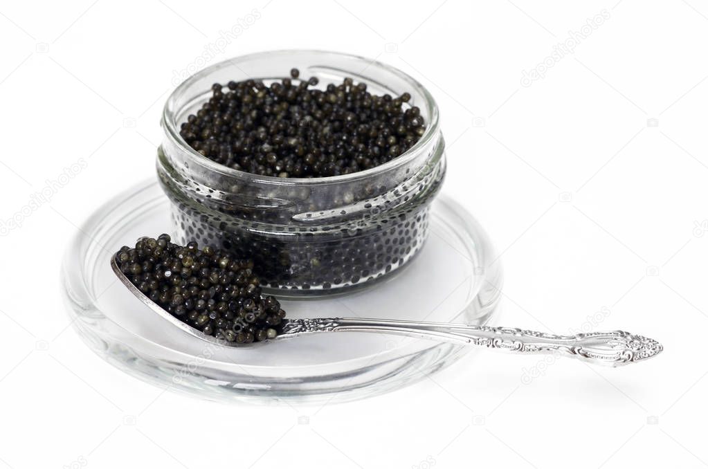 Black caviar in a jar with a spoon