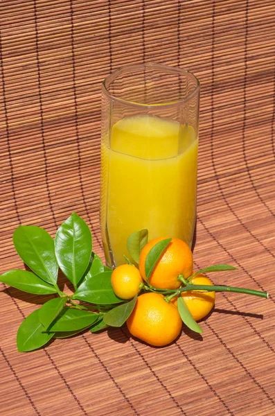 Calamondin tak met fruit en een glas sap van citrusvruchten — Stockfoto
