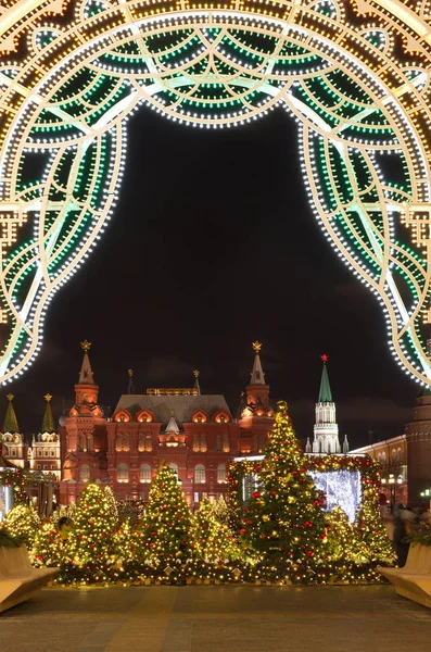 State Historical museum and Moscow Kremlin with beautiful decorated Christmas trees at Manege square evening winter in Moscow, Russia