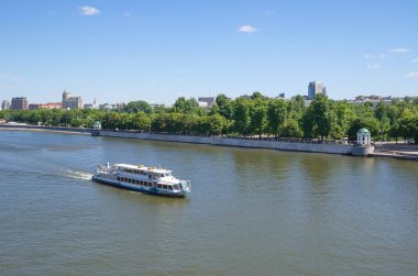 A pleasure boat sails along Pushkinskaya embankment in Moscow, Russia