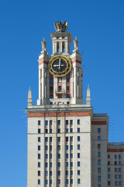Fragment of the main building of the Moscow state University on the Lenin (Vorobyovy) mountains. Clock tower at the main entrance. Moscow, Russia