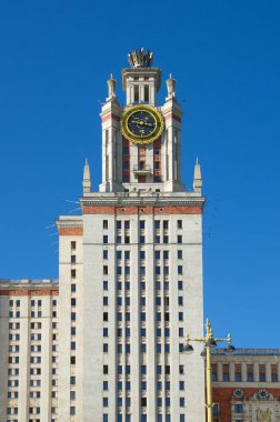 Fragment of the main building of the Moscow state University on the Lenin (Vorobyovy) mountains. Tower with a thermometer at the main entrance. Moscow, Russia