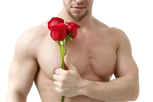 Sexig man ger en ros på vit bakgrund med ett vackert ljus. Isolerad på vit bakgrund — Stockfoto